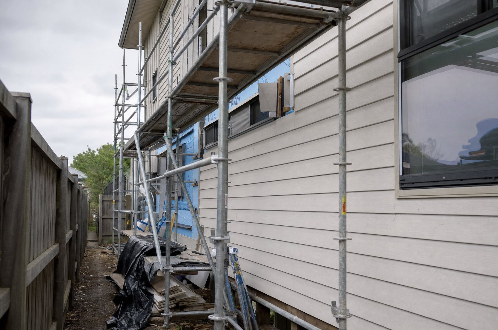 Scaffold erected against the side wall of a two-storey Sydney home during exterior cladding work